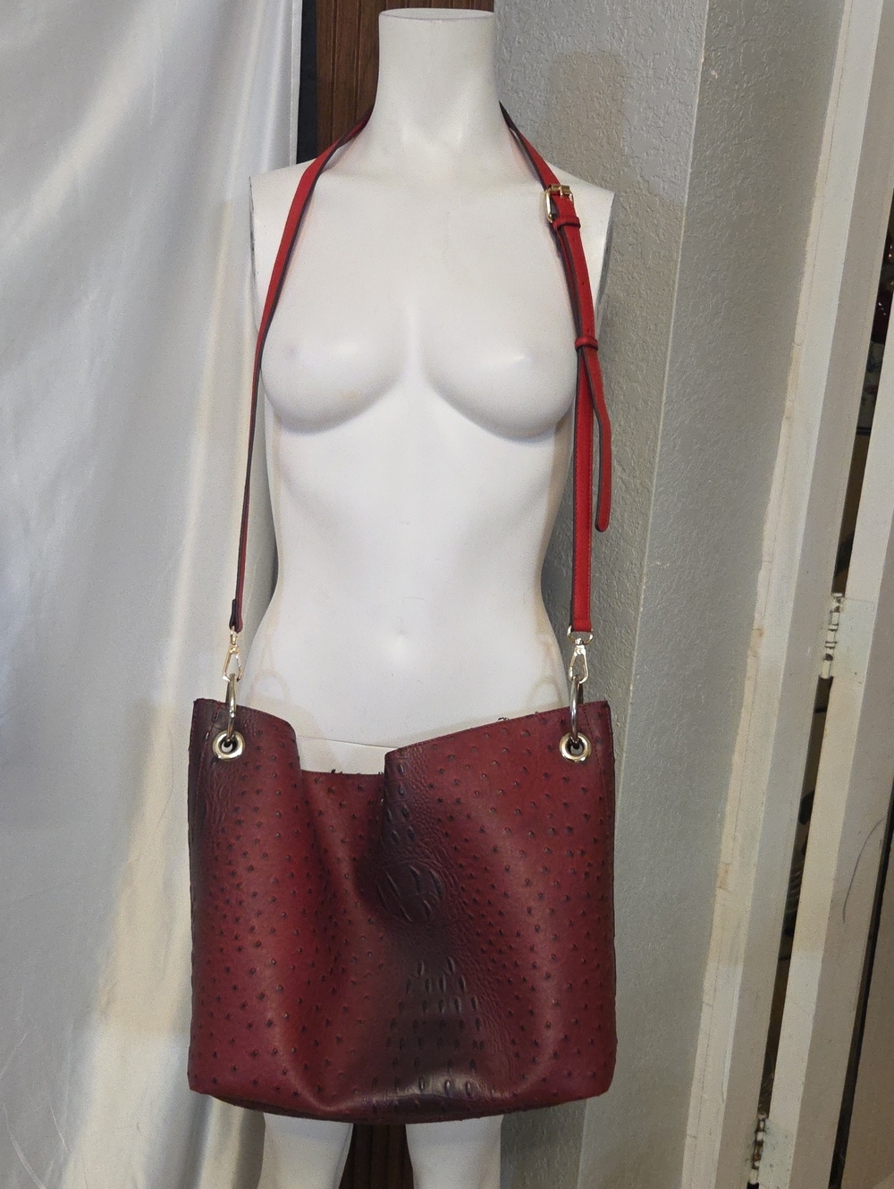 Burgundy Ostrich Embossed Hobo Bag with Contrast Red Shoulder Strap.